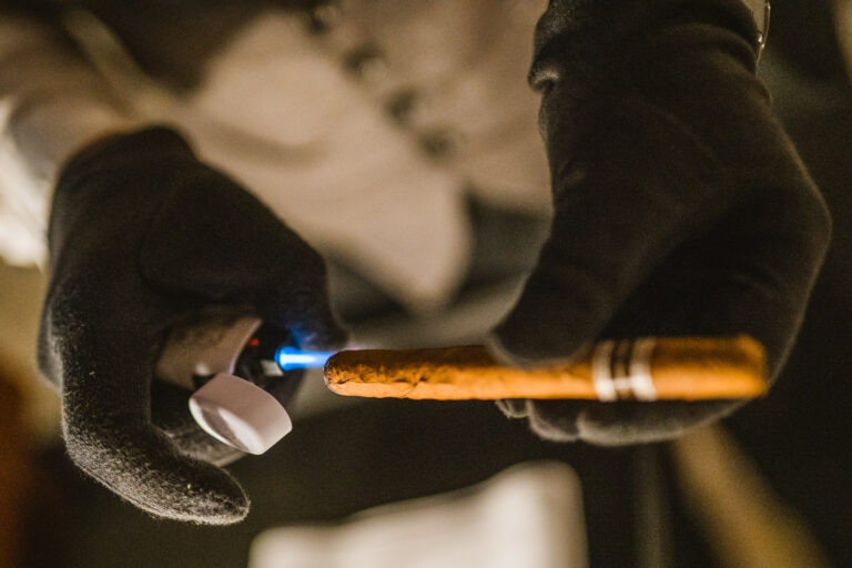 A professional serving a cigar